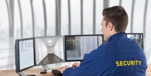 security guard looking images security cameras screens office